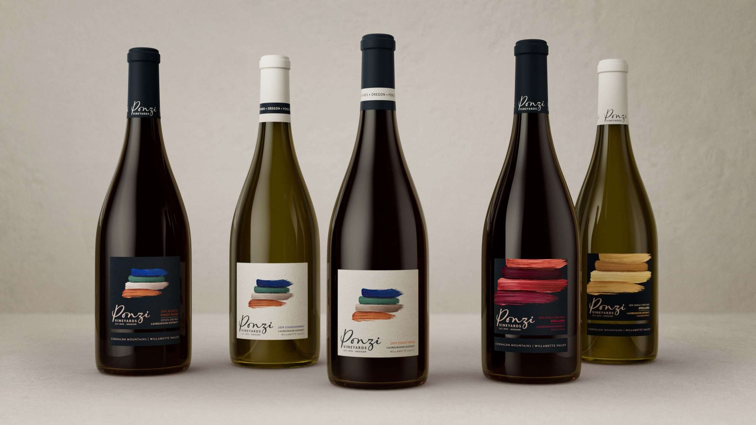 Five Ponzi wine bottles against a white background